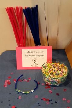 a bowl of candy sits next to a sign that says make a collar for your puppy