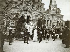 an old black and white photo of people in front of a building