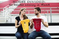 a man and woman sitting on a bench holding shirts