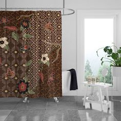 a bathroom with a shower curtain and potted plant next to the window in front of it