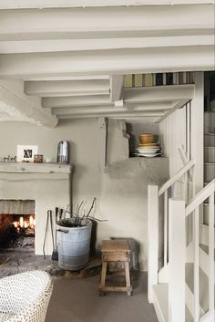 a room with a fire place and shelves on the wall