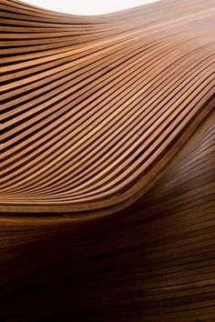 a close up view of a wooden table with wavy lines on the top and bottom