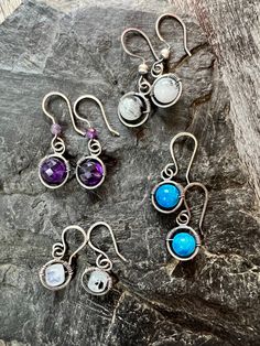 High quality gemstone beads are wrapped in solid sterling silver wire hoops with handmade sterling silver french hooks. Choose from bright blue Chrysocolla, Rainbow Moonstone, Amethyst, or Black Rutile Quartz. These earrings are completely handmade with soldered hoops, wire wrapped beads and hammered 20 gauge ear wires. They each have a drop length of approximately 30 millimeters and are 12 millimeters wide. Black Rutile Quartz, Rutile Quartz, Ear Gauges, Handmade Sterling Silver, Rainbow Moonstone, Silver Wire, Sterling Silber, Moonstone, Gemstone Beads