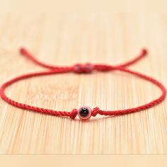 Hand-Made Red Color Single String Bracelet With An Evil Eye For Wrist Sizes 6 To 9 Inches. Wearing An Evil Eye As An Amulet Is Believed To Provide Protection Against Evil Forces. The Evil Eye Meaning Has Symbolism In Almost Every Country In The World And In Every Religion. Red Evil Eye Bracelet For Good Luck, Red Braided Bracelet With Evil Eye For Gift, Adjustable Red Evil Eye Bracelet, Adjustable Black Hand-strung Evil Eye Bracelet, Eye Meaning, Adjustable Red Evil Eye Bracelet, Hand-strung, String Bracelet, Evil Eye Bracelet, Evil Eye