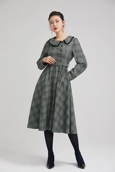 "Simple. With its pleated skirt and grayscale plaid pattern, this vintage wool dress epitomizes classic styling. She's all class and quality with no bells or whistles. Near-perfect vintage condition, designed with lapel collar, long sleeves and tie belt waist, it will be your favorite one of your wardrobe. Details: * 35% wool blend, 35% fiber and polyester, 30% nylon * Polyester lining * long sleeves * tie belt waist * lapel collar * button decoration in front * knee length * back zipper closure Classic Vintage Dress For Work In Fall, Classic Vintage Dress For Fall Workwear, Classic Plaid Dress For Work In Fall, Classic Fall Vintage Dress For Workwear, Classic Vintage Fashion Dresses For Fall, Vintage Plaid Winter Dress, Vintage Plaid Dress For Winter, Elegant Long Sleeve Plaid Dress For Work, Retro Plaid Winter Dresses