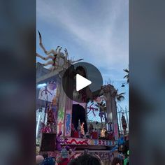 the stage is decorated with colorful decorations and people are standing around it for an event