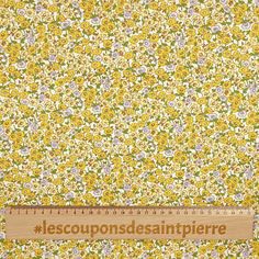 a ruler that is on top of a yellow flowered fabric with the words lescoupons desantipierre