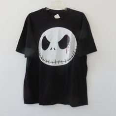 a black t - shirt with the face of jack skellingy from the nightmare