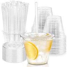 plastic cups with straws and lemon wedges on the top one cup has a drink in it