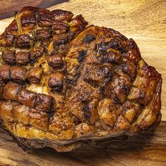 a large piece of meat sitting on top of a wooden cutting board