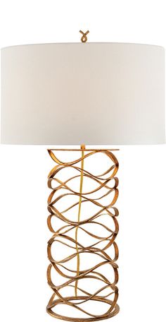 a table lamp with a white shade on the top and a gold metal frame around it