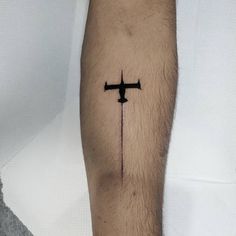 a person with a cross tattoo on their arm