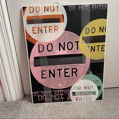 a sign that says do not enter and don't enter on the floor in front of a door