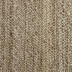 the texture of an upholstered carpet is shown in light brown and beige tones