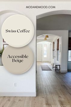 the interior of a house with white walls and wood floors, two round signs that read swiss coffee accessible feege