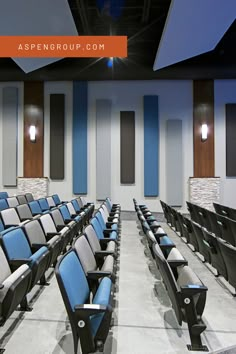 an empty auditorium with blue and gray seats