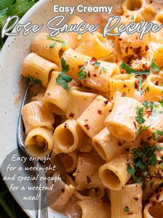 a white plate topped with pasta covered in sauce and garnished with parsley