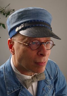 "The HOG HEAD - 1900s-Pattern Railway Engineer's Cap in Vintage Denim, Wabash Stripe Indigo Cloth and Horsehide Peak Hog Head: Railroads Slang - a locomotive engineer. Here is a careful replica of a surviving example of a 1900-1910 denim railway engineer's cap, using the same type of fabrics. The top pieces are built from vintage well-worn denim, and the Wabash-stripe indigo cotton under it has been washed a dozen times to bring the indigo color and texture up. A cowhide leather crown strap is a Vintage Blue Adjustable Hat Bands, Vintage Denim Blue Hat With Curved Brim, Vintage Curved Brim Denim Blue Hat, Vintage Denim Brimmed Hat, Vintage Brimmed Denim Hat, Vintage Denim Blue Cap, Indigo Cloth, Leather Crown, Denim Flats