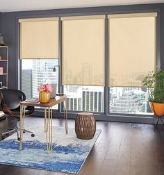 a living room filled with furniture and windows covered in roller shades over the top of them