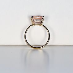 Beautiful emerald cut peachy pink color morganite ring, diamond hidden halo ring. DETAILS ABOUT THE RING!* 9x7mm emerald cut morganite is peach pink color.* Ring band is 1.3mm 14k solid yellow gold* Emerald cut 4 prong setting is 14k solid yellow gold* Set 20 white diamonds in the hidden halo, total 0.05 ct. weight. Elegant Morganite Radiant Cut Rings, Elegant Radiant Cut Morganite Rings, Elegant Morganite Rings With Baguette Cut, Radiant Cut Morganite Rings For Anniversary, Morganite Ring For Proposal, Morganite Ring Jewelry For Proposal, Morganite Gemstone Jewelry For Proposal, Formal Emerald Cut Morganite Jewelry, Morganite Rings With Accent Stones