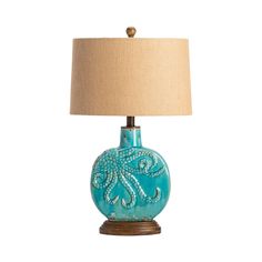 a blue lamp with a beige shade on it