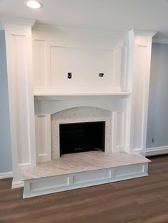 an empty room with a fireplace in the middle and no mantles on either side