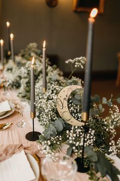 the table is set with candles and flowers