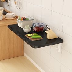 a kitchen counter with cutting board, bowls and utensils sitting on top of it