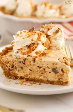 a piece of pie on a white plate with a fork next to it and another slice in the background