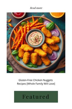 a plate with fried chicken nuggets and carrots on it, surrounded by other foods