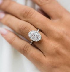 a woman's hand with a diamond ring on her finger