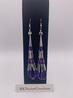 Beautiful hoop earrings made in silver and purple colors. Beads are size  11 seed bead, opaque. 3 rows of  bead strands that form 3 hoops. Length from  top of hook to bottom is 5 inches. These earrings are light weight, and a  beautiful to match any outfit and social setting.  These earrings are made with quality size 11 Czech beads, bugle beads, silver .75" cones and 3mm silver beads. Earrings will arrive in a box and padded mailer. A tracker # will be provided.  Earring are designed and made at MKNativeCreations. Purple Tassel Drop Earrings With Dangling Beads, Purple Beaded Fringe Drop Earrings, Purple Earrings With Beaded Fringe, Purple Jewelry With Beaded Fringe And Round Beads, Purple Beaded Fringe Dangle Tassel Earrings, Purple Beaded Fringe Tassel Earrings, Purple Beaded Dangle Tassel Earrings, Silver Adjustable Earrings With Beaded Fringe, Purple Beaded Earrings With Dangling Round Beads