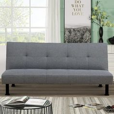 a gray couch sitting on top of a wooden floor