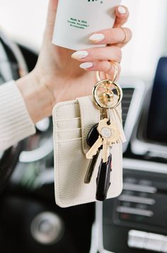 These double-sided wallet keychains are the perfect combination of minimalism and function. This credit card wallet has a button clasp for added security and a trendy tassel keyring. The Nina is the minimalist wallet of your dreams! Each one comes with a super cute tassel, reinforced with gold hardware. Two keyrings come attached, including one with a clasp to make it super easy to attach your keys! Details: made from soft and durable vegan leather gold hardware with 2 key rings 4" wide x 3" tal Small Wallet With Keychain, Wallet On Keychain, Cute Wristlet Keychains, Wallet Keychain Aesthetic, Wallet And Keys Aesthetic, Wallet Keychain Ideas, Cute Wallet Aesthetic, Aesthetic Car Keys, Keychain With Wallet