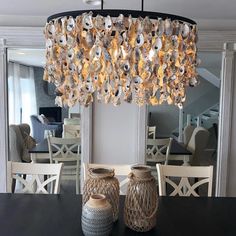 a chandelier hanging over a dining room table