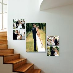 a couple standing next to each other in front of stairs with pictures on the wall