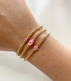 14k gold filled or sterling silver bracelet with a pink and mother of pearl evil eye bead. The evil eye comes in small, medium, and eye shape. This bracelet is made in elastic stretch form with no clasp. Pink Beaded Bracelets With Evil Eye, Pink Beaded Bracelet With Evil Eye, Pink Bracelets With Evil Eye Round Beads, Pink Evil Eye Bracelets With Round Beads, Cheap Pink Evil Eye Bracelets, Pink Adjustable Evil Eye Bracelet Trendy, Pink Evil Eye Beaded Bracelet, Pink Beaded Evil Eye Bracelet, Pink Evil Eye Round Beads Bracelets