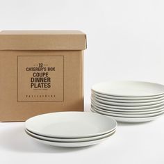 white dinner plates in front of a cardboard box