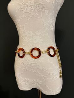 Quality Tortoishell ring belt with Gold Chain.  This fashionable belt is perfect for dresses, swimwear, resort wear, gifts.  Exclusively designed by FAN Design, FAN Fashion Hand made in a range of sizes.  Teen sizes though to waist size 60". For larger belts send me a convo.  Perfect wardrobe accessory or gifts. Ring Belt, Fan Fashion, Belt Gold, Wardrobe Accessories, Fan Design, Waist Chain, Chain Belt, Perfect Wardrobe, Suspender Belt