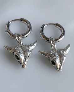 Beautiful baby bull earrings made in pure .925 sterling silver. Can be worn as a single earring, as a pair or shared with your bestie. The perfect gift for any occasion. Measurements: Length - Bull is 0.8 inches (20.6 mm) from hoop Width - 9 mm from edge to edge at widest point Hoop - 12 mm x 2 mm Details: Hand carved Latch back infinity hoops Hoop is sterling silver plated Bull charm is pure .925 sterling silver Made in Los Angeles Every item is made to order just for you. Please allow 5-10 bus Sterling Silver Tarnish-resistant Cartilage Earrings As Gift, Hypoallergenic Silver Huggie Plug Earrings, Symbolic Silver Tarnish Resistant Earrings, Symbolic Silver Tarnish-resistant Earrings, Symbolic Tarnish-resistant Silver Earrings, Silver Sterling Dangle Cartilage Earrings, Symbolic Silver Sterling Silver Plug Earrings, Bull Earrings, Bull Skull