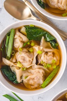 a white bowl filled with dumplings and vegetables