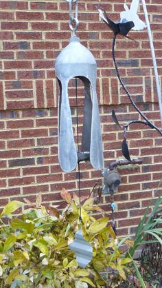 a bird feeder hanging from the side of a brick building