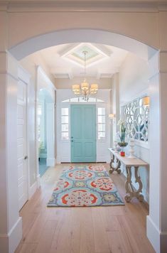 a blue door is in the middle of a hallway with a rug on the floor