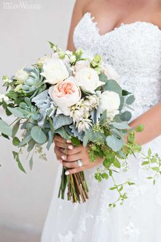 a bride holding a bouquet of flowers in her hands