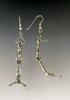 the silver earrings are made from metal wire and have dangling hooks on each earring