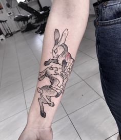 a person with a rabbit tattoo on their arm