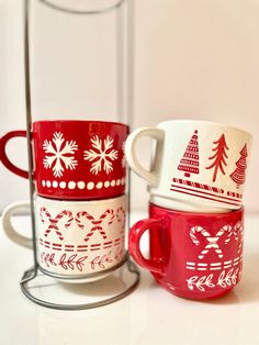 two red and white mugs sitting next to each other