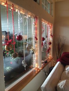 christmas decorations are hanging on the windowsill