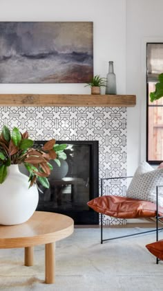 a living room filled with furniture and a large potted plant on top of a table