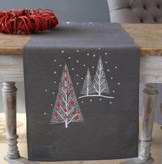 a christmas table runner with trees on it